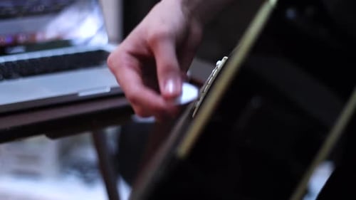 Recording playing the acoustic guitar. Strumming guitar. Up-close of man playing guitar. Changing ch