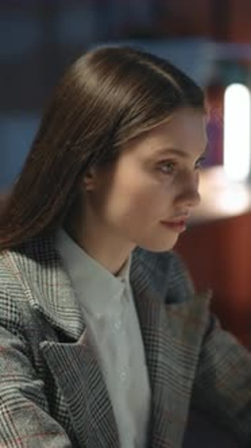 Late Night Young Corporate Woman in Suit Typing Computer Keyboard Working Long Hours Office Interior