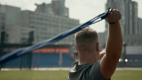 Man Stretching with Resistance Band Outdoors