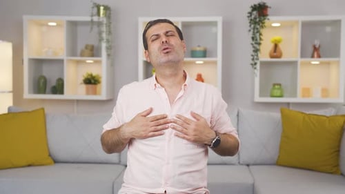 Man Experiences Chest Pain Sitting on Couch