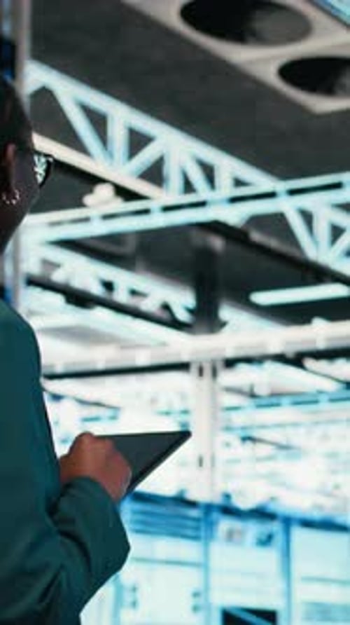 Vertical Video Data Center Programmer Writing Code for Resource Optimization Using Tablet