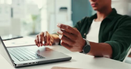 Young Adult Working at Desk With Laptop