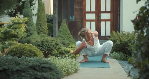 Man Does Yoga Poses in Tranquil Garden