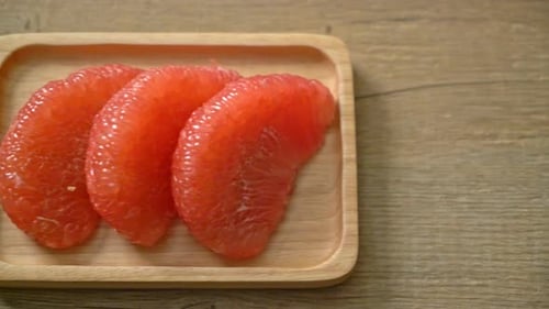 Red Pomelo Fruit on a Wooden Platter