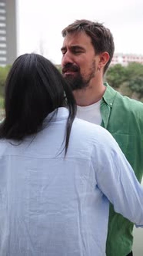 Smiling Couple Hugs in Urban Park