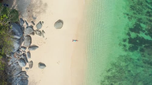 Aerial Top View on Woman in Swimsuit Relaxing and Sunbathing on Beach White Sand Near the Sea
