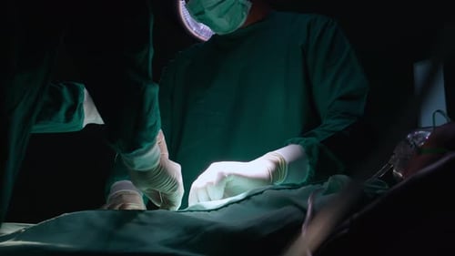 Group of team doctor and surgeon doing surgery with patient in the operation at hospital.