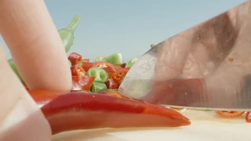 I cut hot red pepper against the background of other sliced pieces. Super close-up.