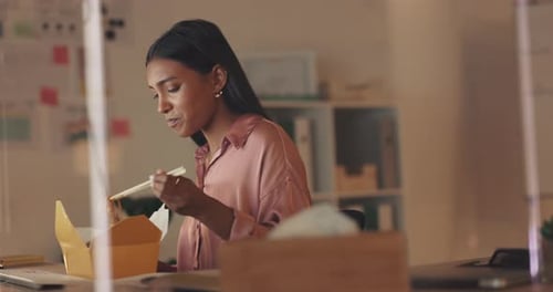 Woman Eats Take Out Lunch at Her Desk