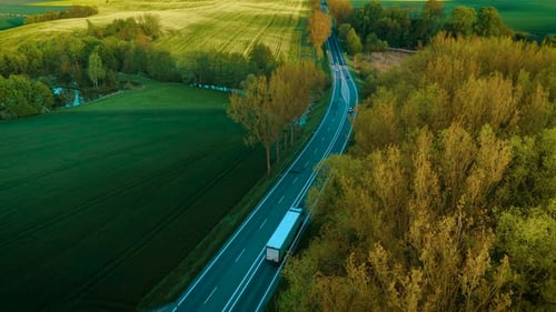 Driving Road Truck Through Forest and Countryside for Logistics and Delivery of Goods By Freight