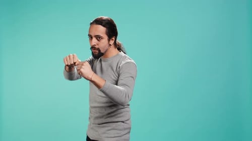Man in Boxing Stance on Blue Background