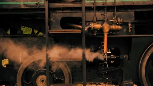 Historical Steam Engine Train Locomotive Driving on Railroad Tracks