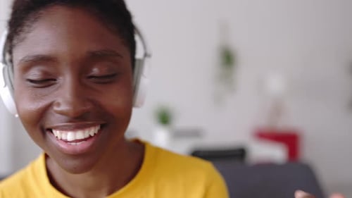 Young Woman Listening to Music with Headphones