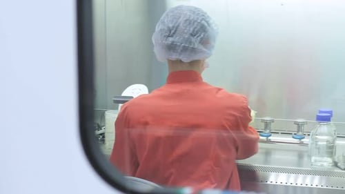 Scientist Working in Laboratory With Protective Gear