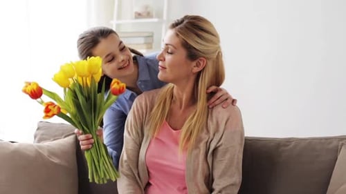 Girl Surprises Mother with Flowers and Affection