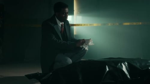 Man Kneeling at Crime Scene Puts on Gloves