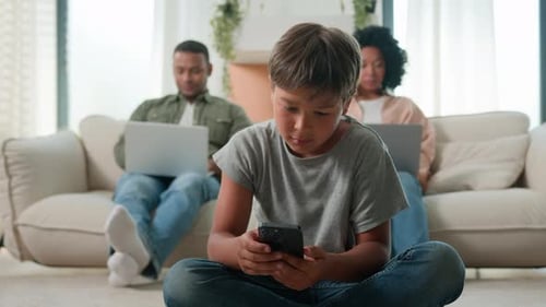 Family Relaxing at Home with Electronic Devices
