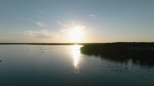 aerial drone shot of boats on a large lake at sunset