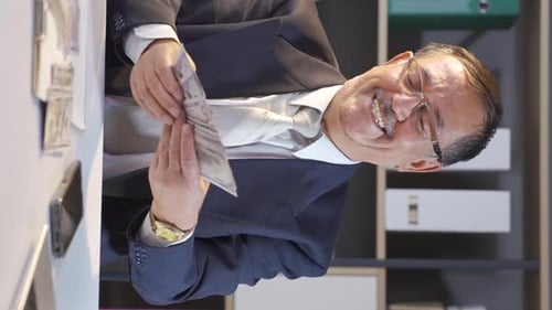 Vertical video of Businessman scattering money, happy and cheerful.