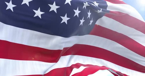 Realistic Waving American Flag Against a Clear Blue Sky