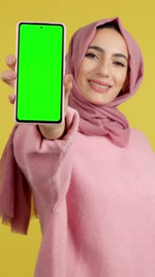 Green Screen of the Mobile Held By a Muslim Woman