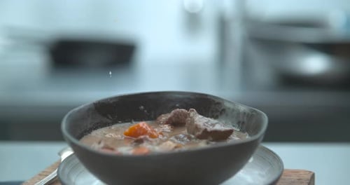 Hearty Beef Stew Being Ladled Into Ceramic Bowl Closeup in Ultra Slow