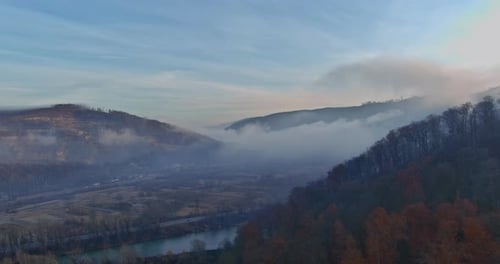 A Morning Valley with Mystic Forest Fog Enveloping Carpathians Mountain Forests Can Be Seen From