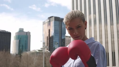 Woman with Boxing Gloves Practices in City