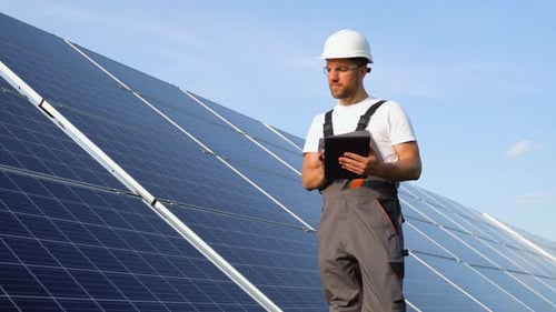 Handsome Male Mechanic Standing Outside Near Solar Panels Holding Tablet Man Seting Up Alternative