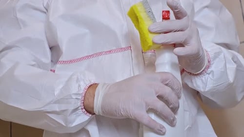 Cleaning with Protective Suit and Cleaning Supplies