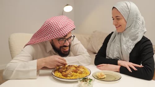Muslim Couple Enjoying Traditional Arabic Dinner at Home
