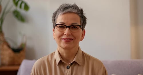 Smiling Woman with Gray Hair, Close-up Portrait at Home