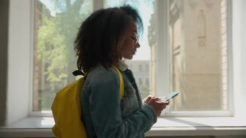 Side View African American Student Girl Female Schoolgirl Woman Lady Walking in Corridor College