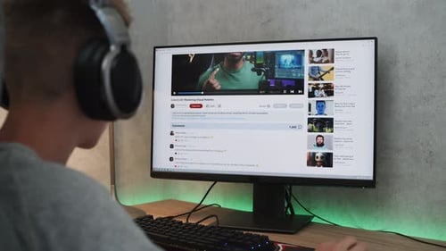 Caucasian Teenager Watches Video About Color Grading on Personal Computer