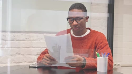 Young Adult Reviewing Documents Indoors
