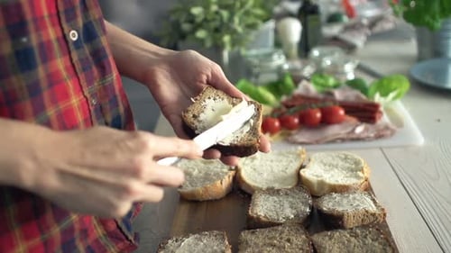 Woman Spreading Butter On Bread In Kitchen, Super Slow Motion 240fps