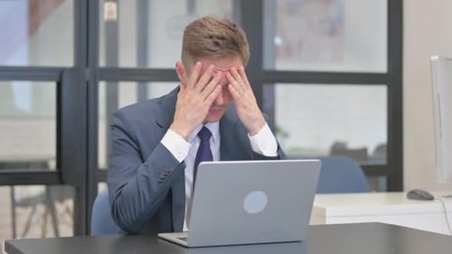 Man Experiences Headache While Working on Laptop