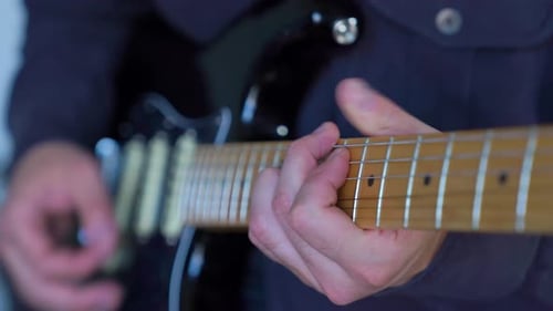 Man Plays Electric Guitar Close Up