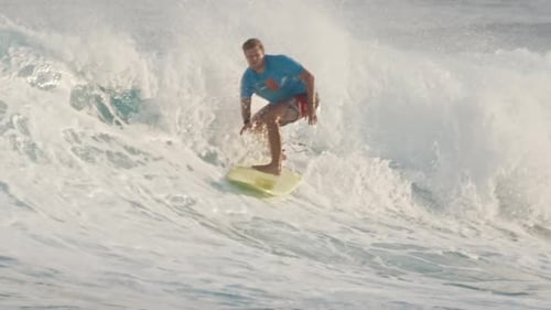 Male Surfer Rides the Wave in the Ocean