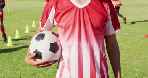 Video of biracial male football players with ball on field