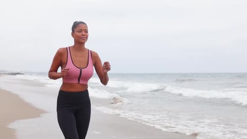 Mixed ethnicity woman working out at the beach