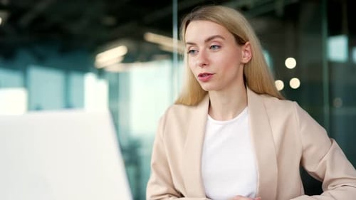 Woman in Office Video Call Discussing Project
