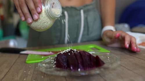 Sprinkling Sesame Seeds on Beetroot Slices