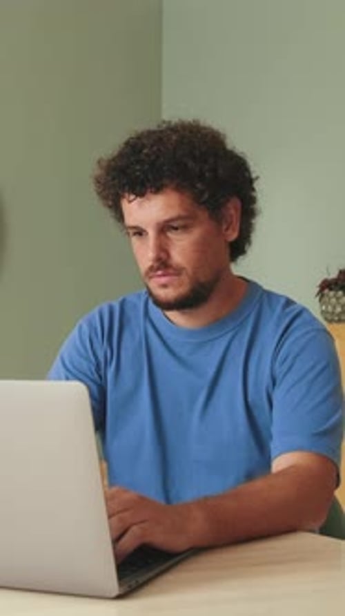 Young Adult Typing on Computer at Home