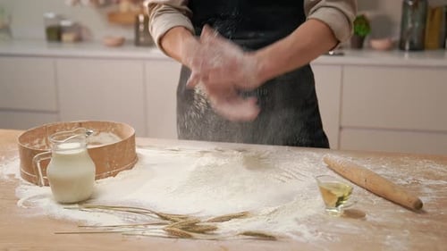 Baker Clapping Floury Hands in the Kitchen