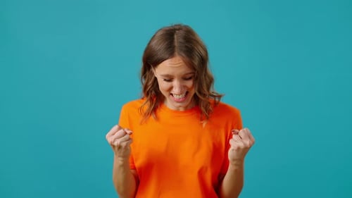 Woman Expressing Many Emotions Against Blue Background