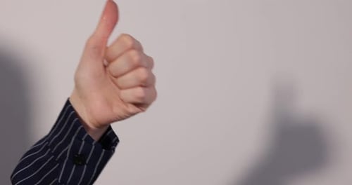 Woman's Hand Giving a Thumbs Up Gesture
