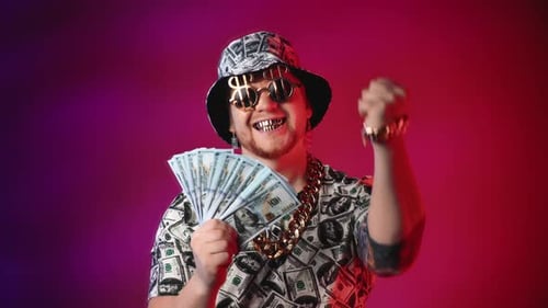 Man Celebrates Success with Stack of Hundred Dollar Bills