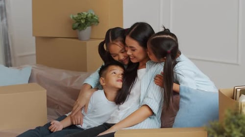 Die Familie genießt eine schöne Zeit miteinander beim Auspacken von Kartons im neuen Zuhause