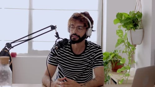 Young Man Streaming Radio Podcast Online at Home Studio